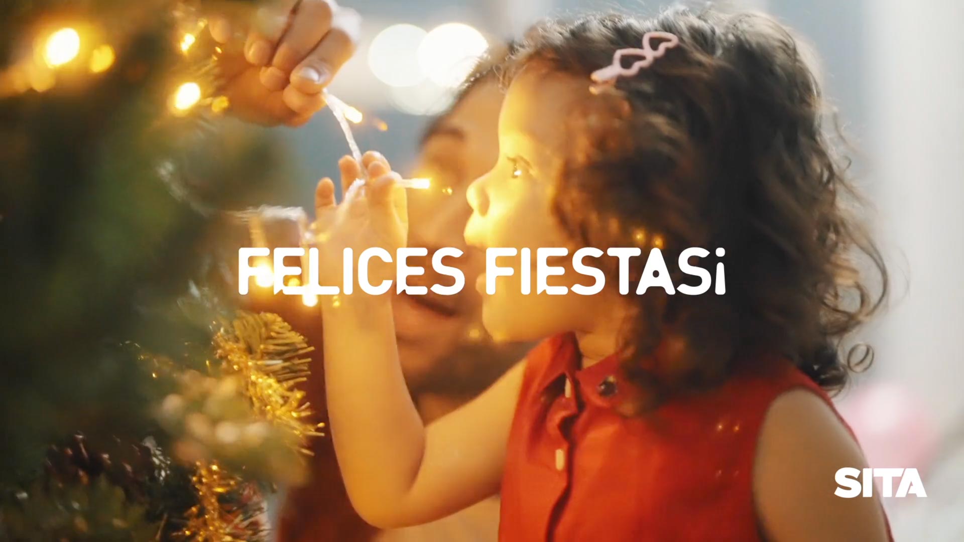 child with Christmas tree and lights